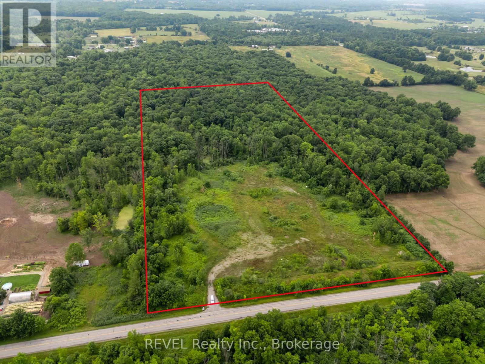 An aerial view of a property with a red outline indicating the boundary.