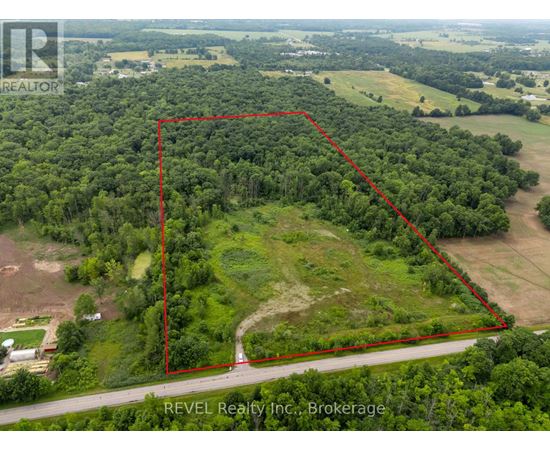 An aerial view of a property with a red outline indicating the boundary.