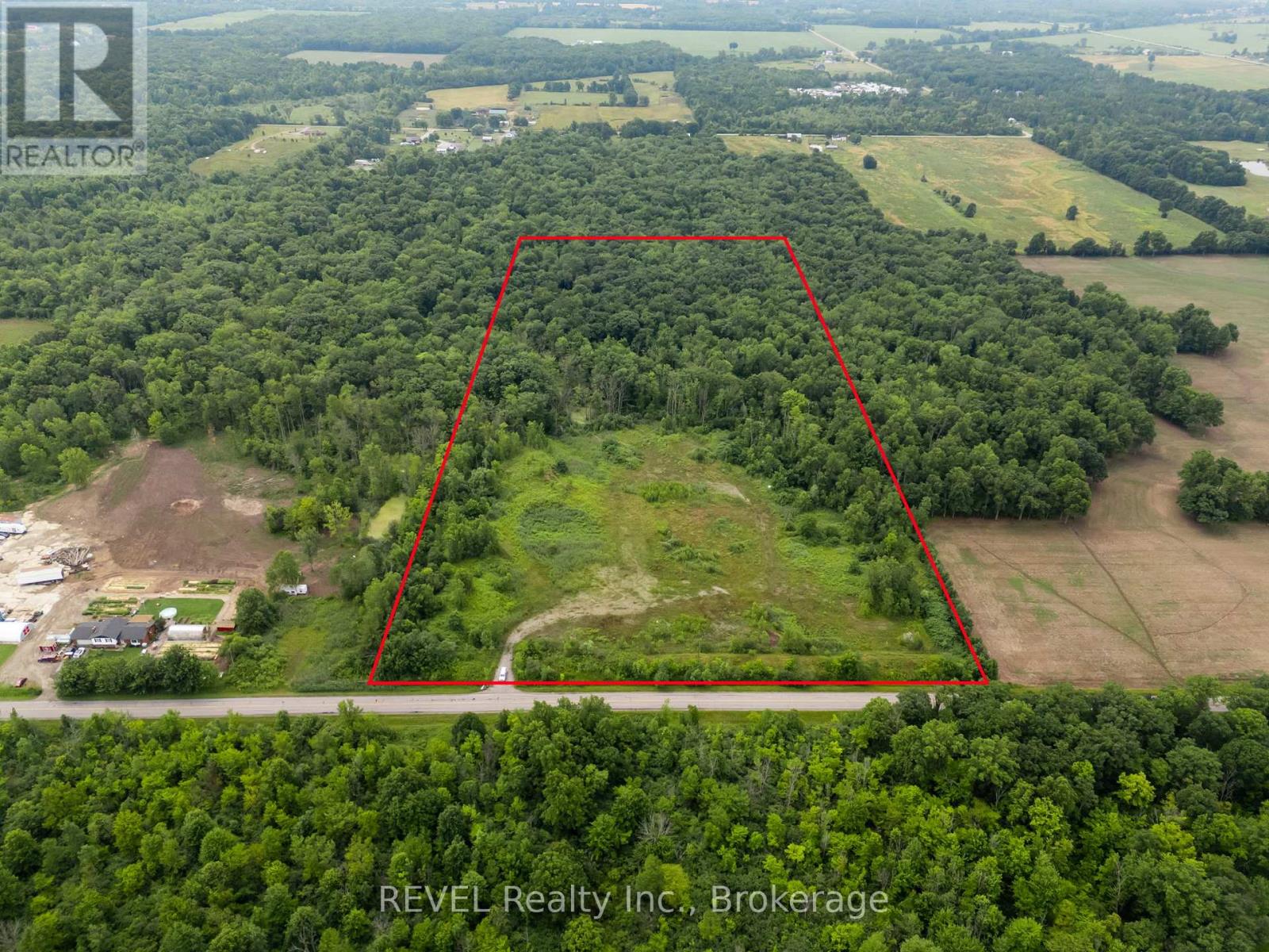 An aerial view of a property with a red outline indicating the boundary.