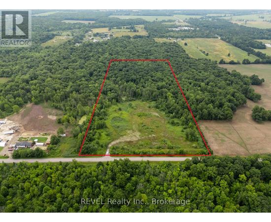 An aerial view of a property with a red outline indicating the boundary.