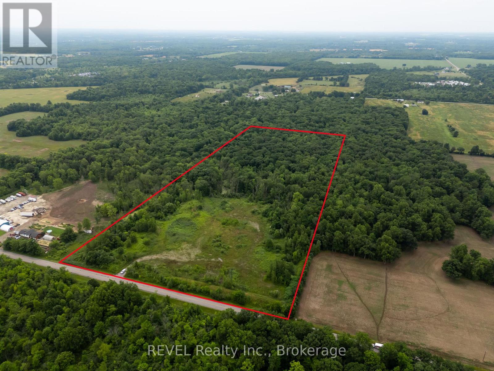 An aerial view of a property with a red outline indicating the boundary is for sale.