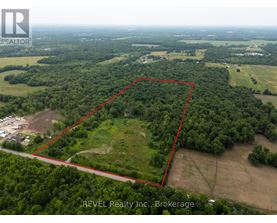 An aerial view of a property with a red outline indicating the boundary is for sale.