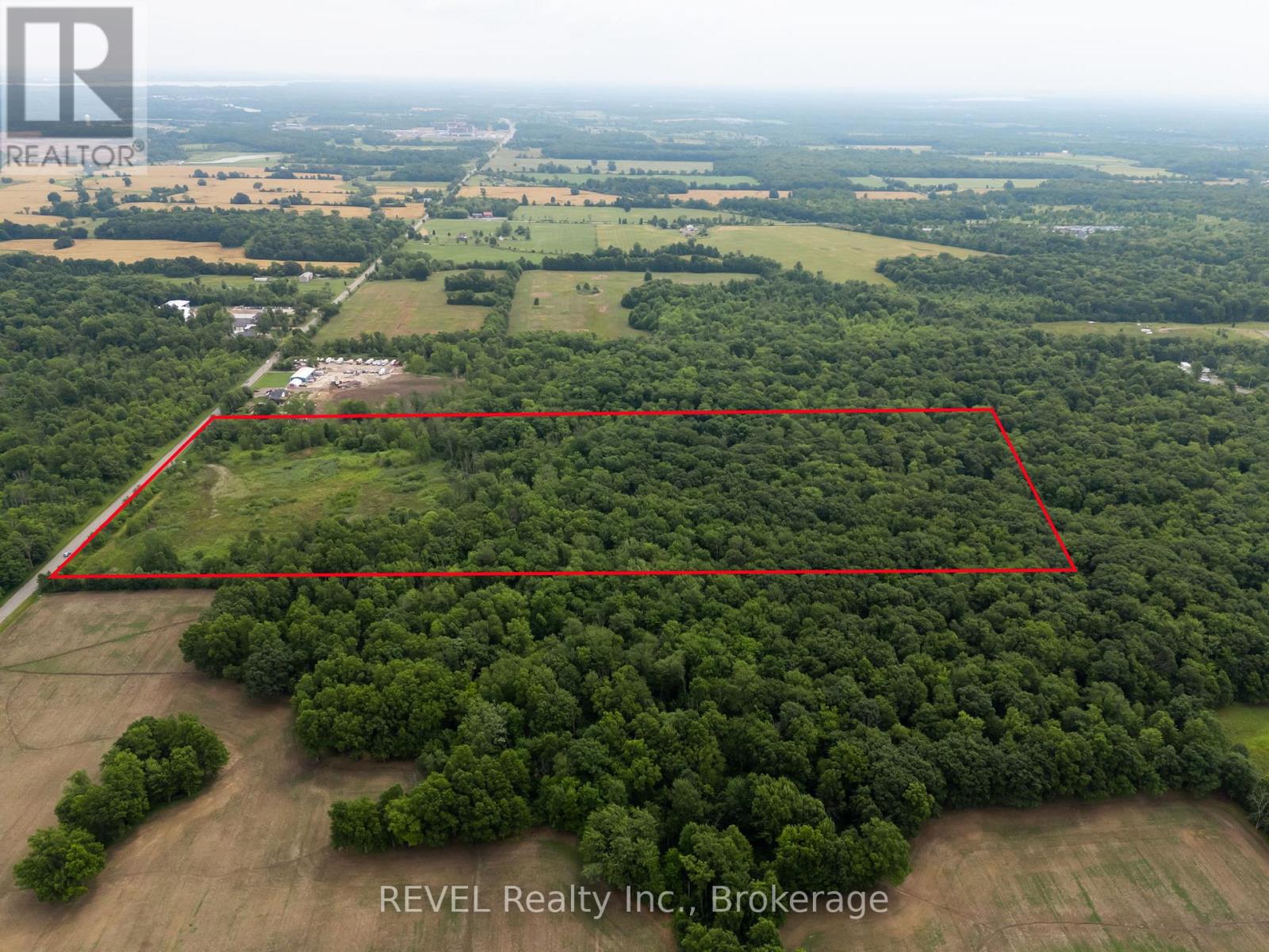 An aerial view of a property with a red outline indicating a specific area for a real estate listing.