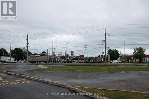 A street view with a sign for RE/MAX Rise Executives, Brokerage.