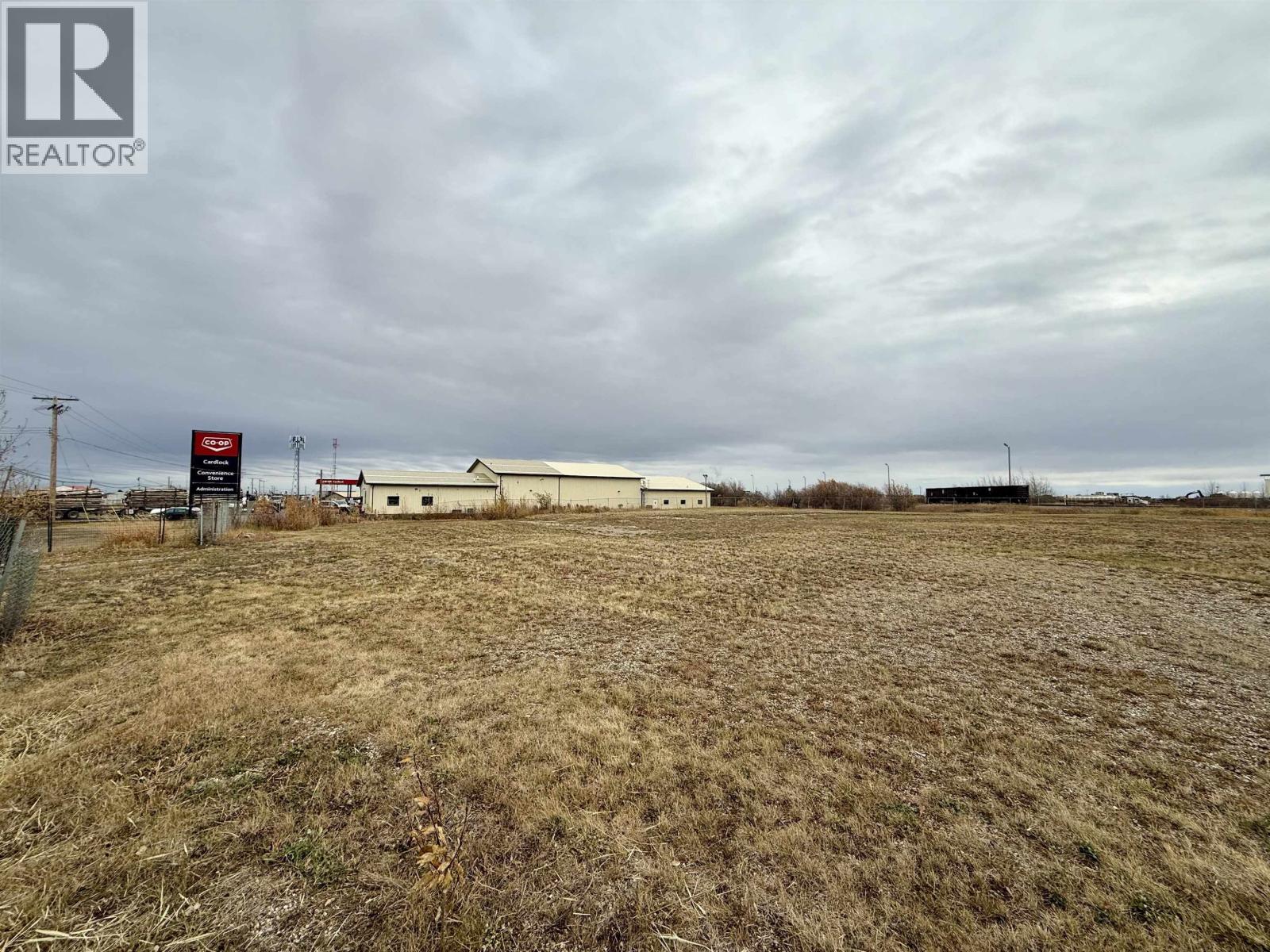 A field with a REALTOR® sign in the foreground.