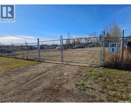 A fenced lot with a sign that says "LOT 3".