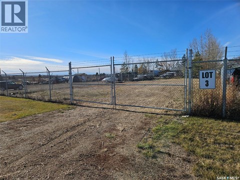 A fenced lot with a sign that says "LOT 3".