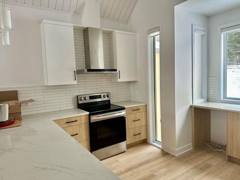 A kitchen with a stove and oven, and a countertop.