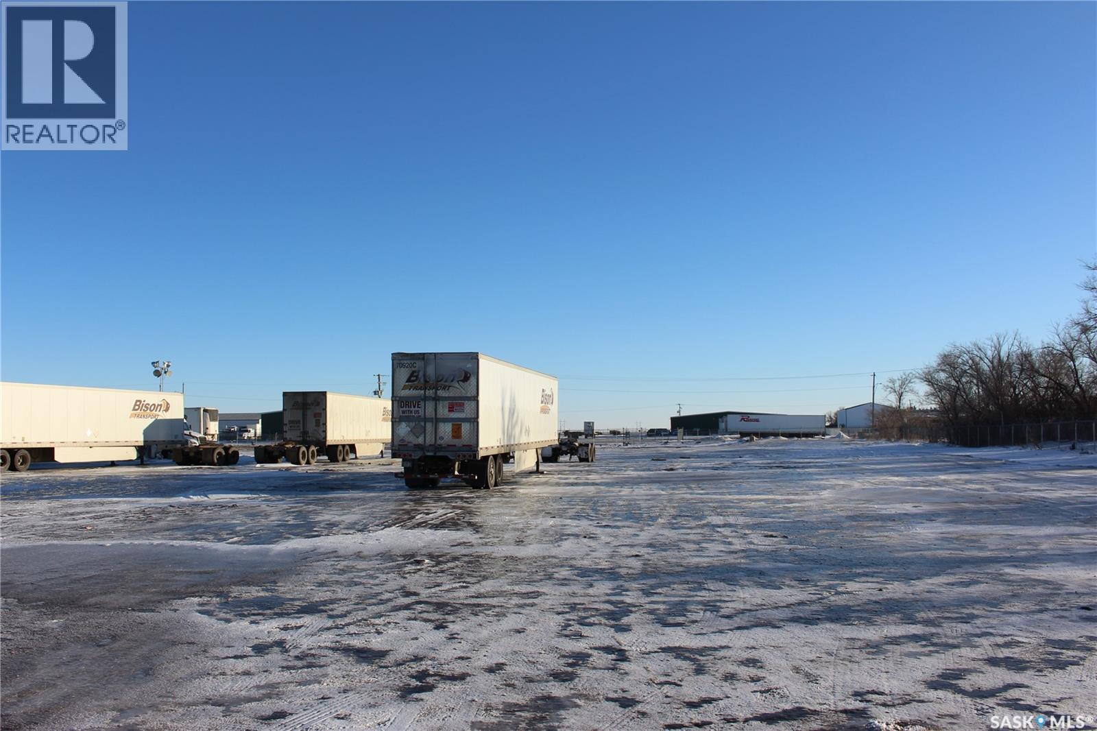 A large white truck is parked in a snowy lot.