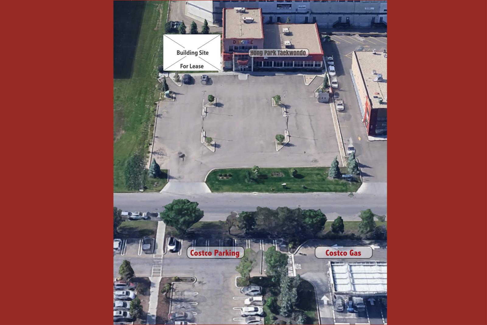 An aerial view of a parking lot with a building for lease and a Costco Gas station.