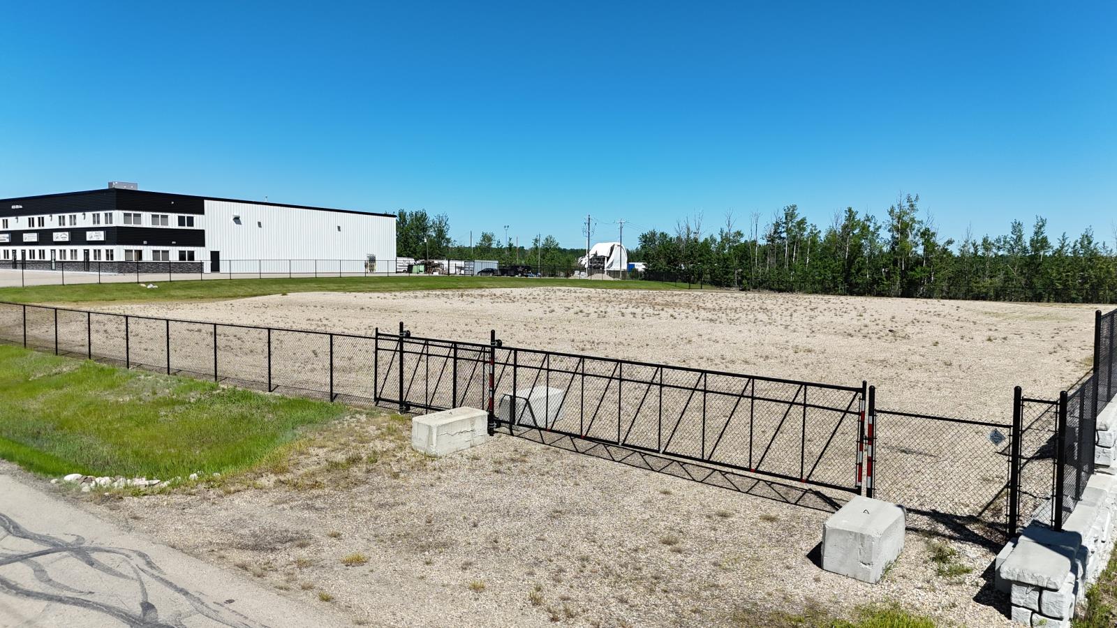 A white building with a black fence in front of it.