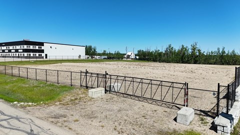 A white building with a black fence in front of it.