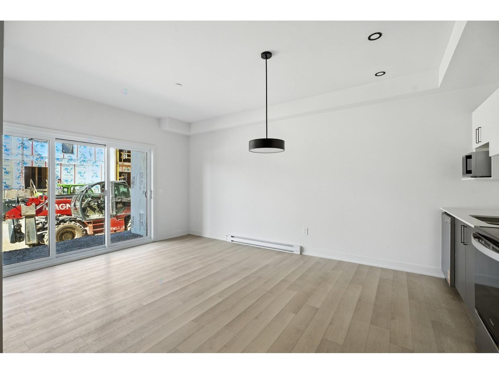 A room with a wooden floor and a ceiling light.