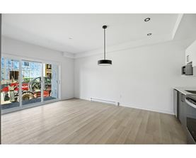 A room with a wooden floor and a ceiling light.