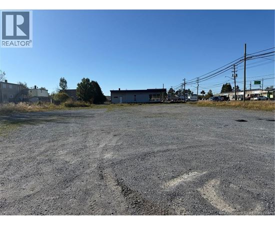 A large, empty parking lot with a building in the background.