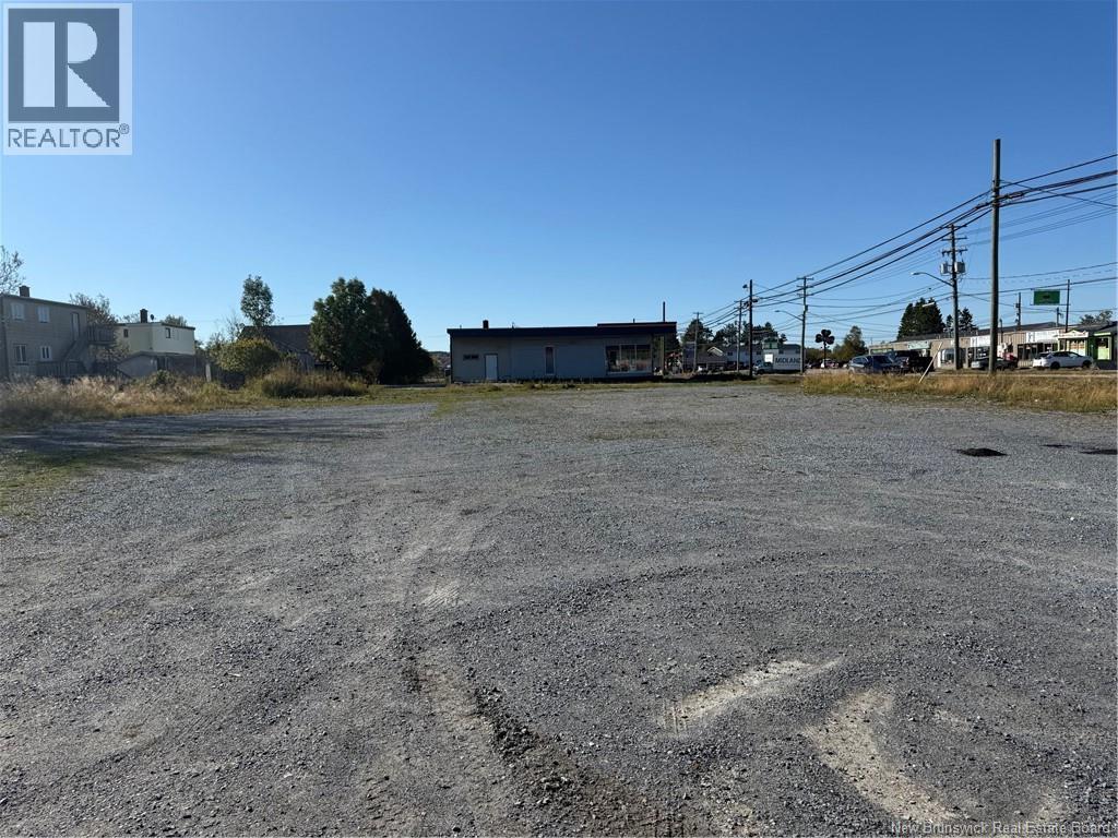 A large, empty parking lot with a building in the background.