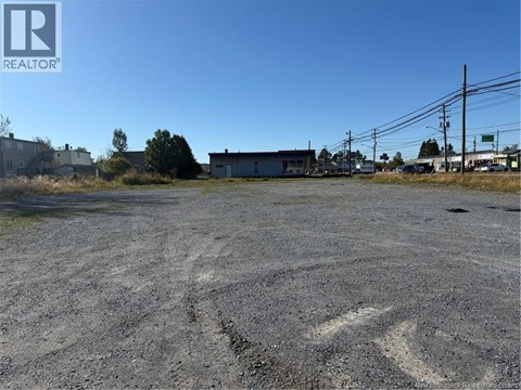 A large, empty parking lot with a building in the background.