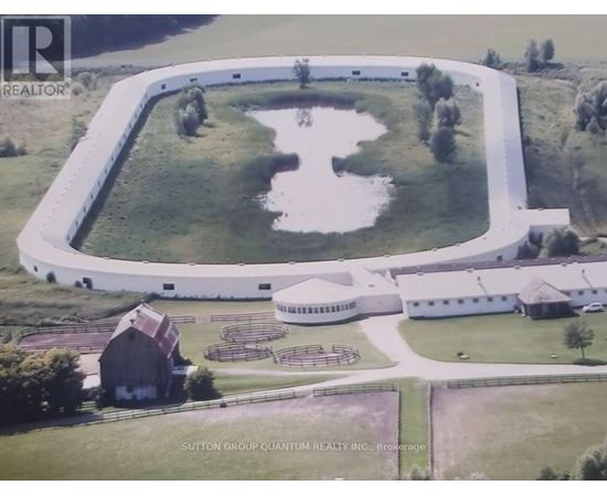 A large white building with a pond in front of it.
