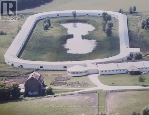 A large white building with a pond in front of it.