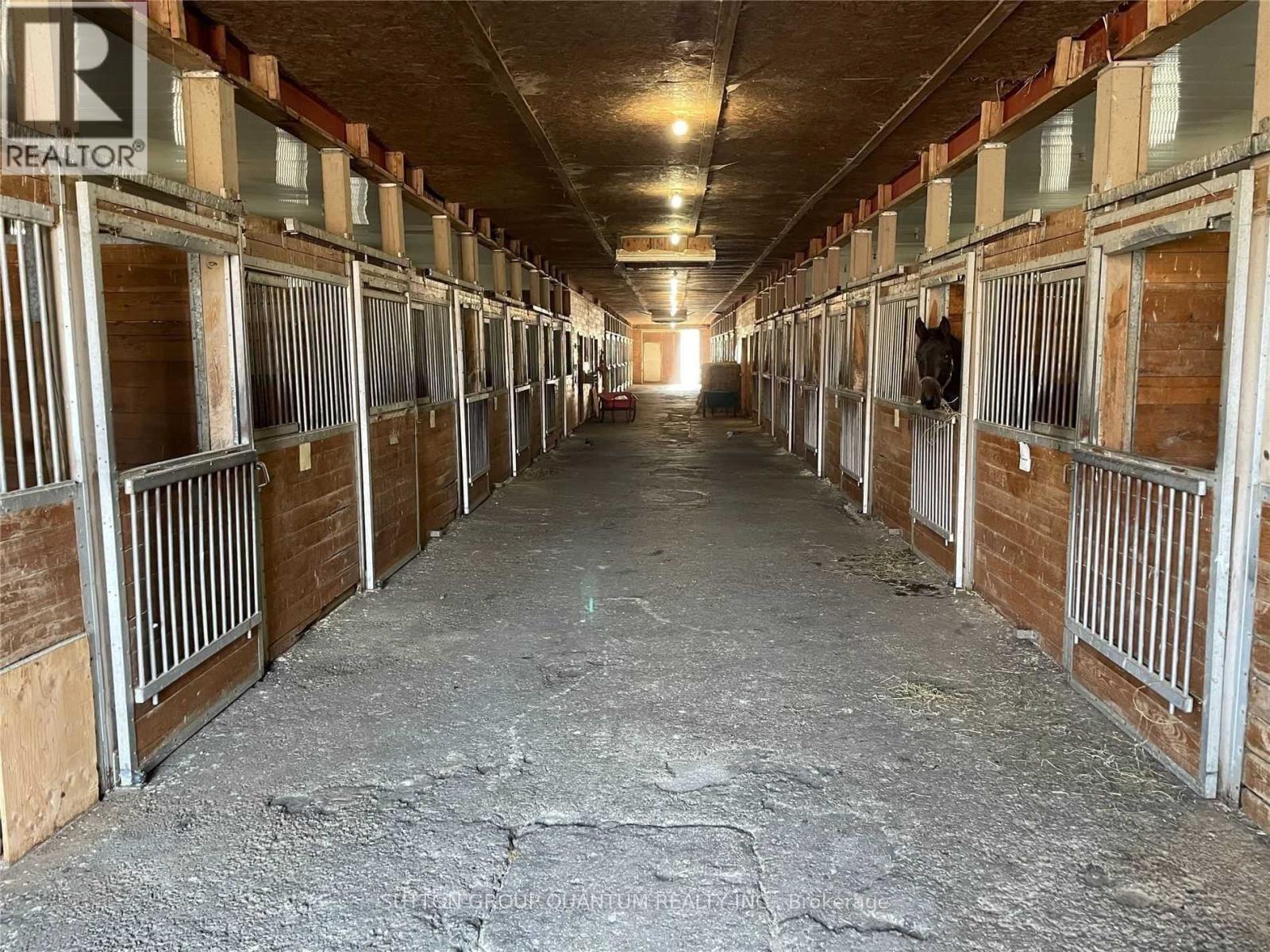 A long, narrow stable with multiple stalls.