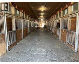 A long, narrow stable with multiple stalls.