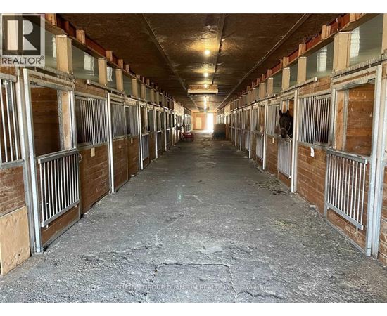 A long, narrow stable with multiple stalls.
