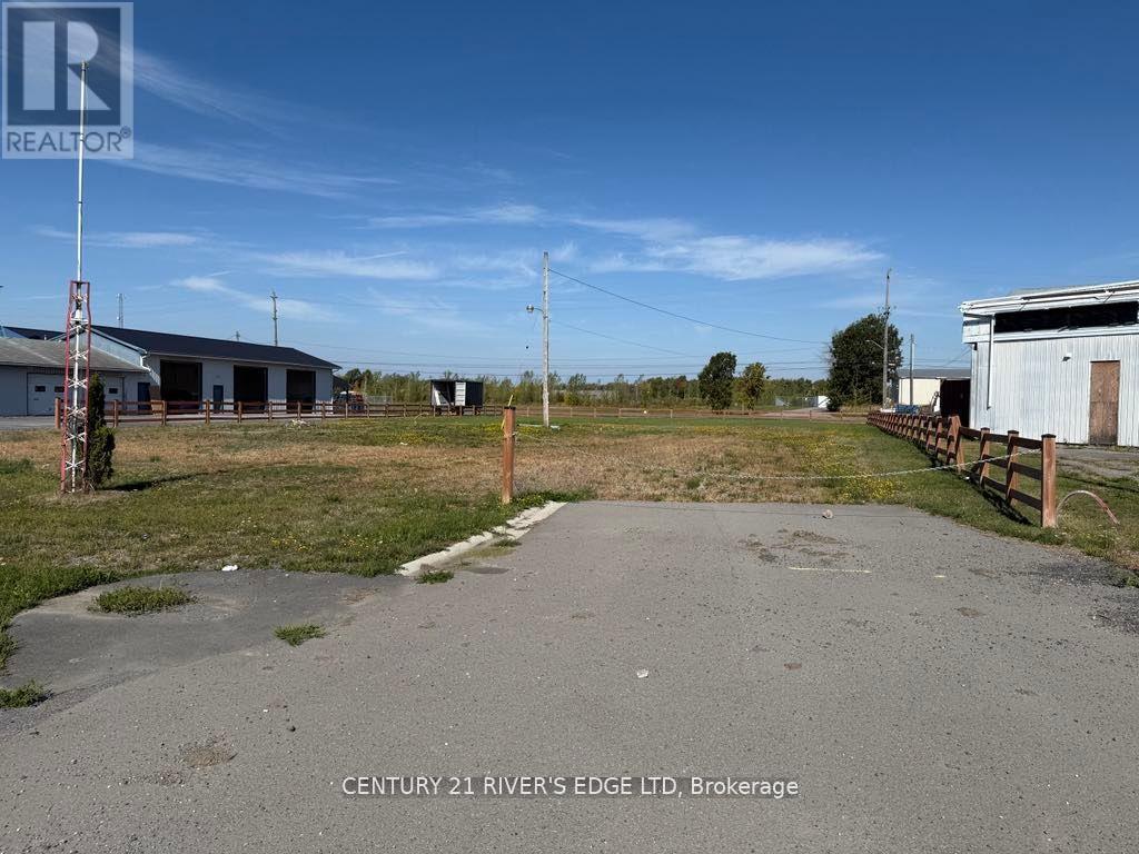 A realtor photo of a property with a building and a fence.