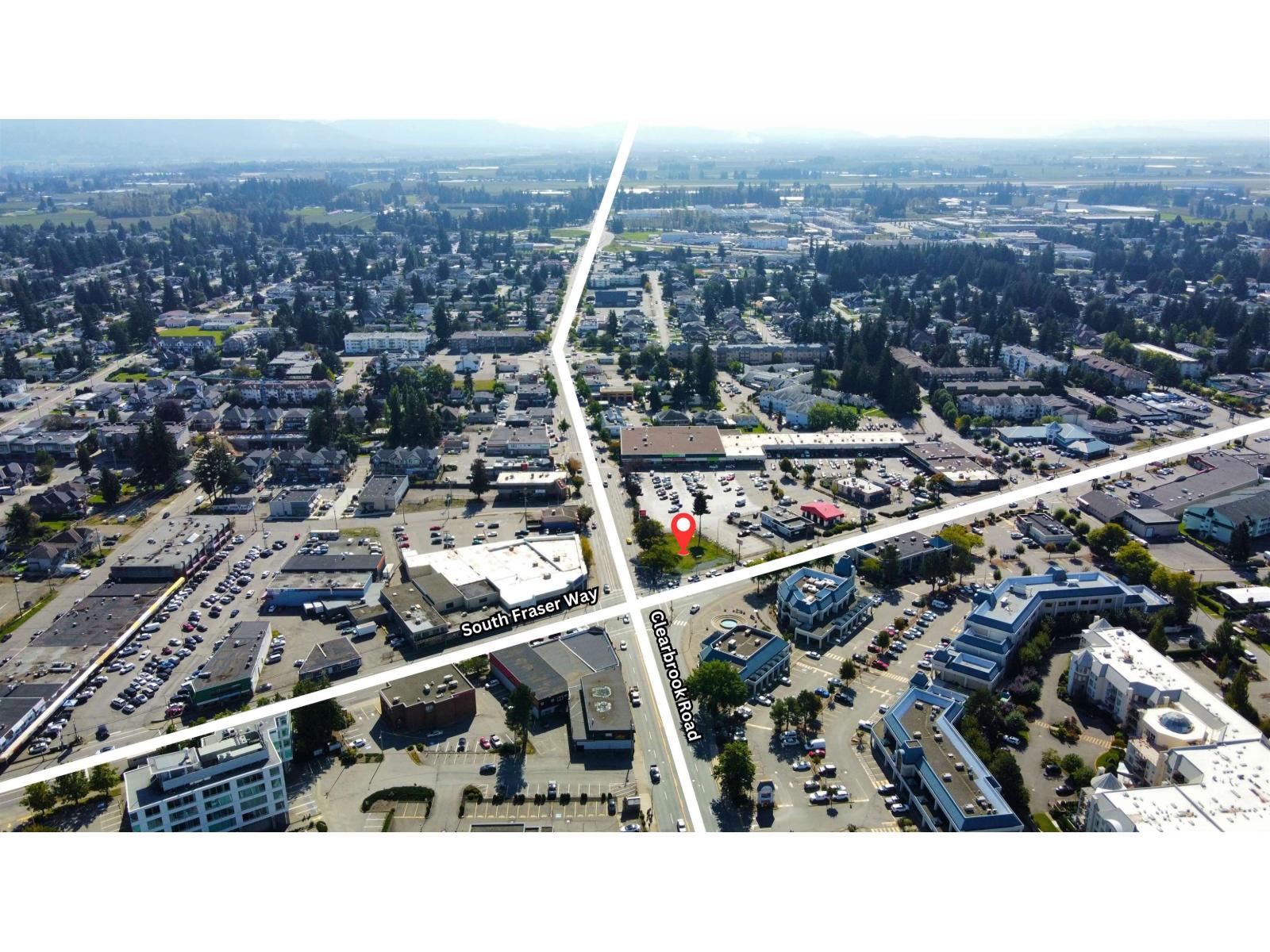 A bird's eye view of a city with a road running through the middle.