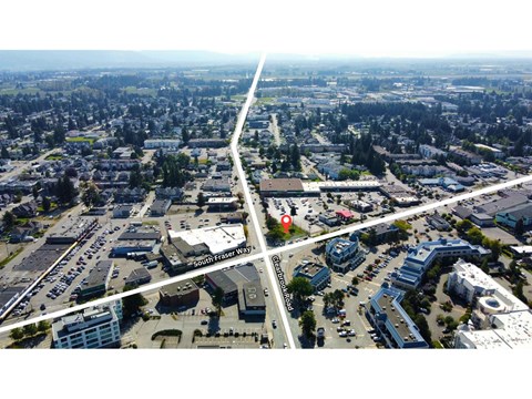 A bird's eye view of a city with a road running through the middle.