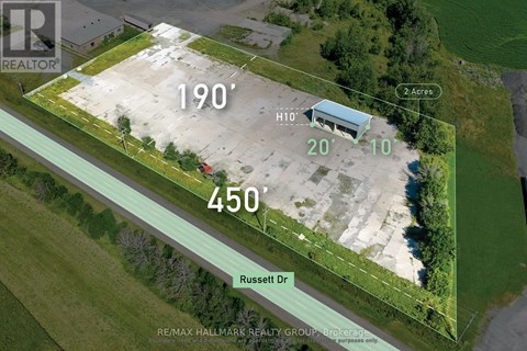 An aerial view of a property with a green border and a building in the center.