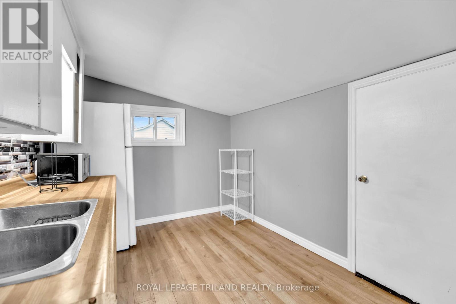 A kitchen with a sink and a window.