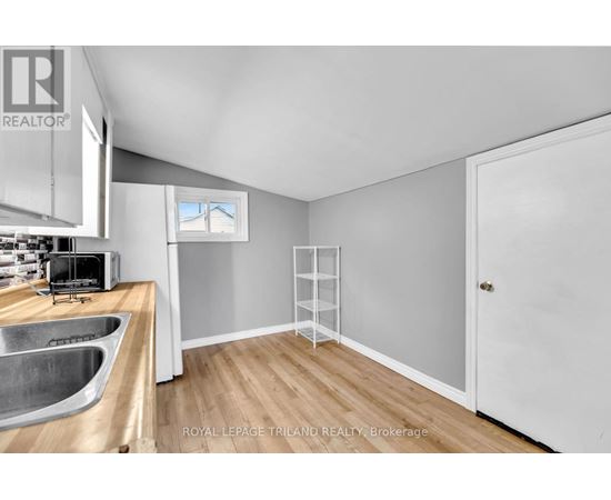 A kitchen with a sink and a window.