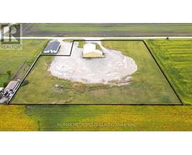 A property listing image shows a large open field with a small house and a shed.