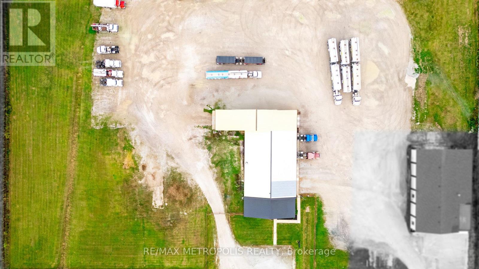 A construction site with a large building under construction and several vehicles parked around it.