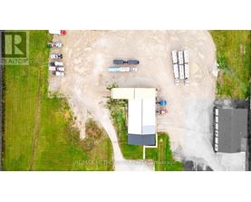 A construction site with a large building under construction and several vehicles parked around it.