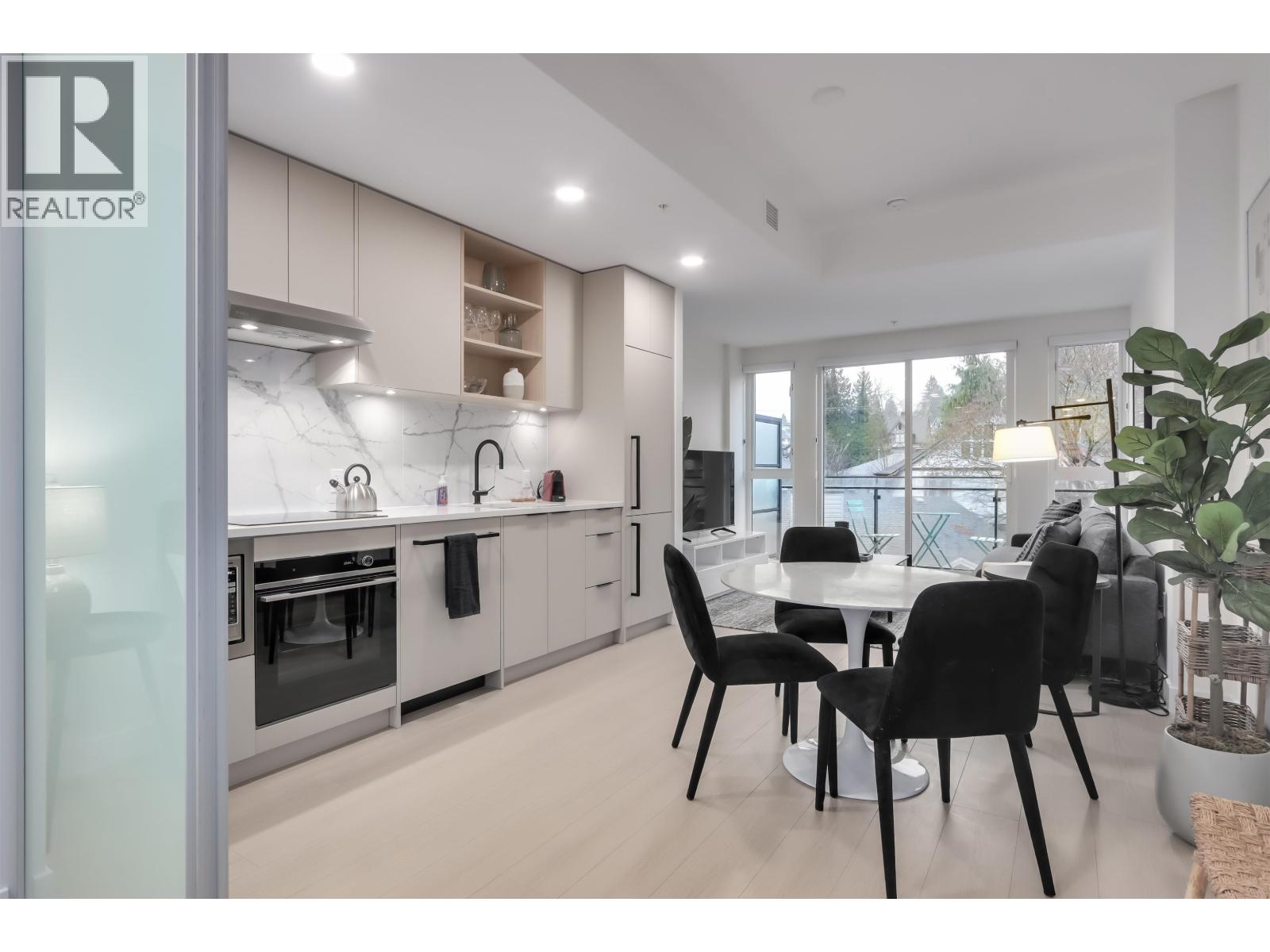 A modern kitchen with a dining table set up.