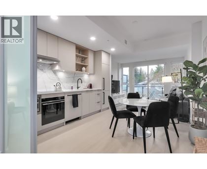 A modern kitchen with a dining table set up.