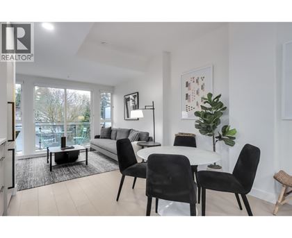 A modern living room with a dining table set up.