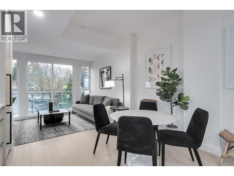 A modern living room with a dining table set up.