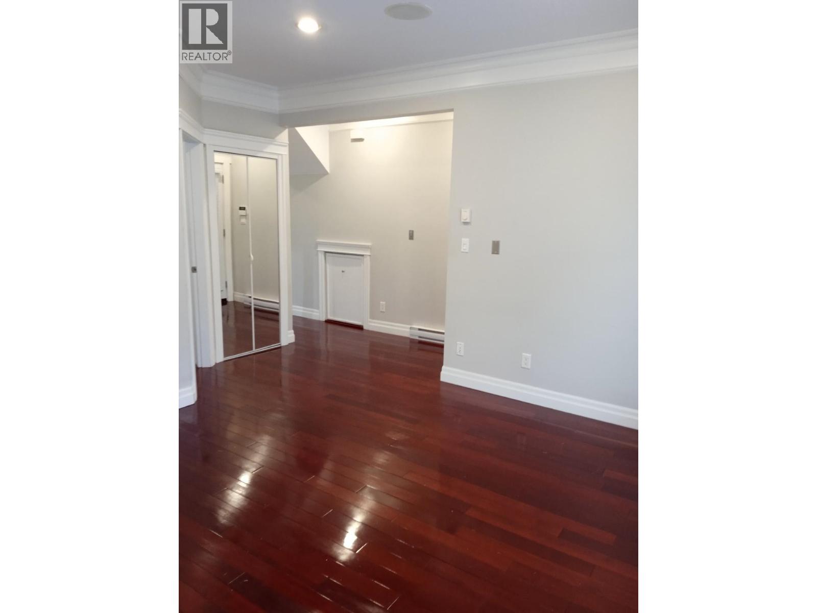 A room with wooden floors and white walls.