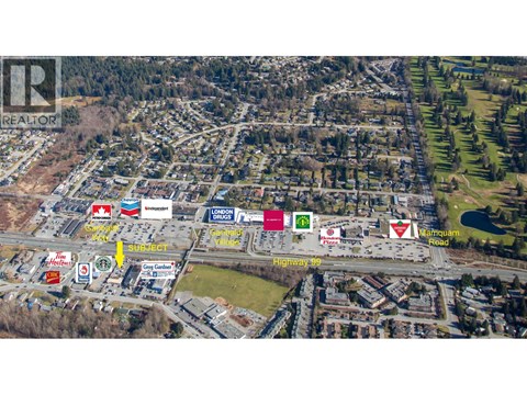 An aerial view of a shopping center with various stores including a Londoner and a gas station.