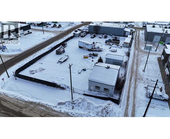 A snowy landscape with a building and a car.