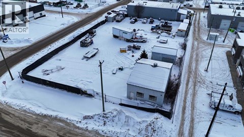 A snowy landscape with a building and a car.