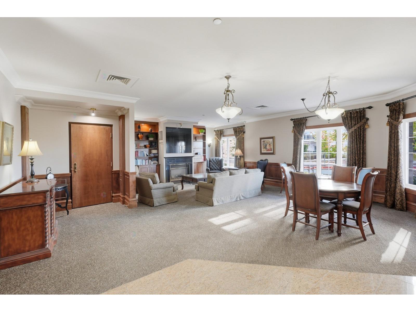 A spacious living room with a dining table and chairs.