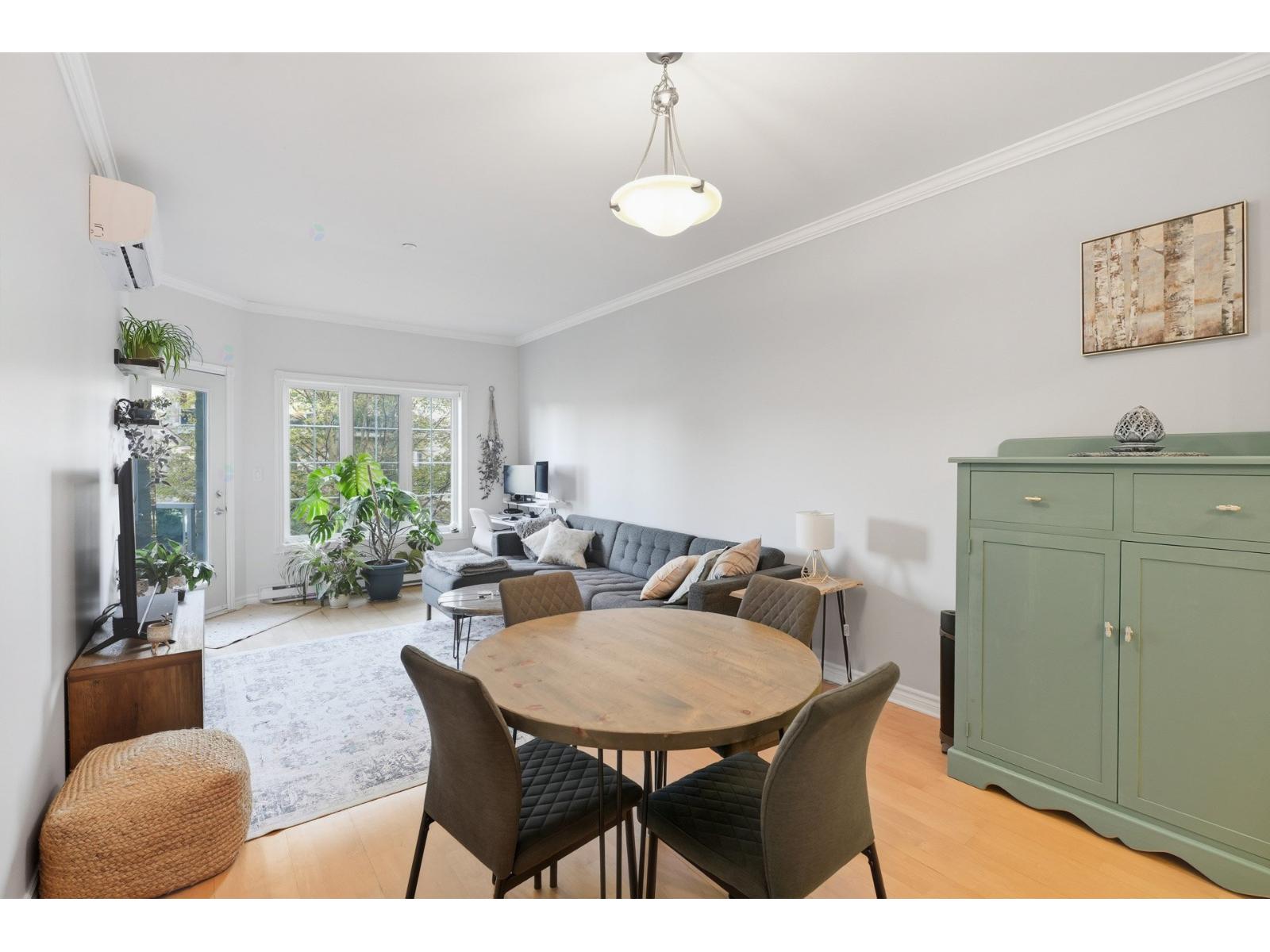 A dining room with a wooden table and chairs.