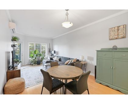 A dining room with a wooden table and chairs.