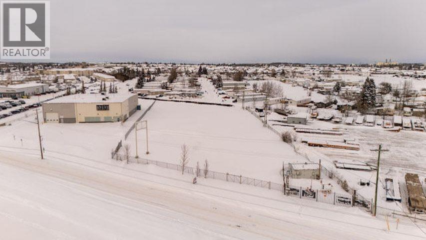 A snowy landscape with a building and a sign that says REALTOR.