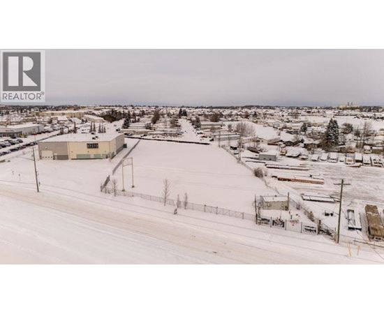 A snowy landscape with a building and a sign that says REALTOR.