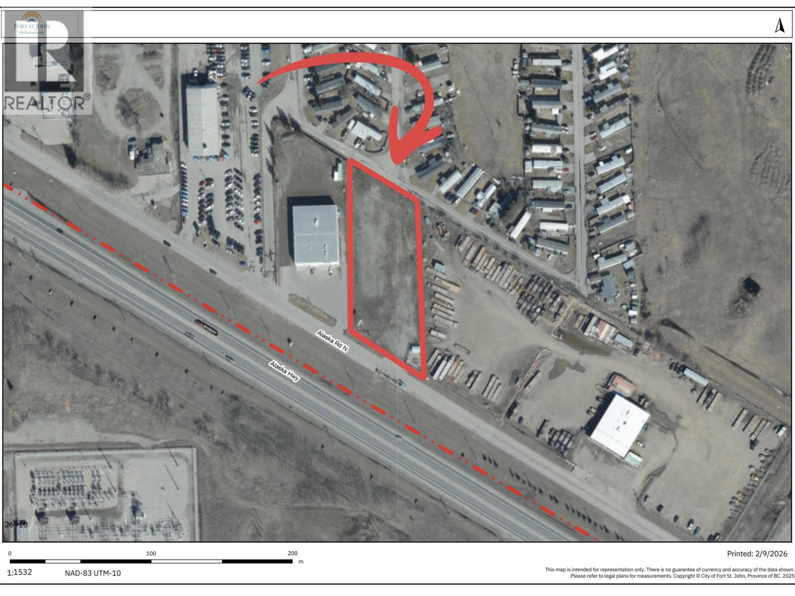 A satellite image of a property with a red outline and a dashed line running through it.