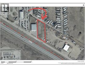 A satellite image of a property with a red outline and a dashed line running through it.